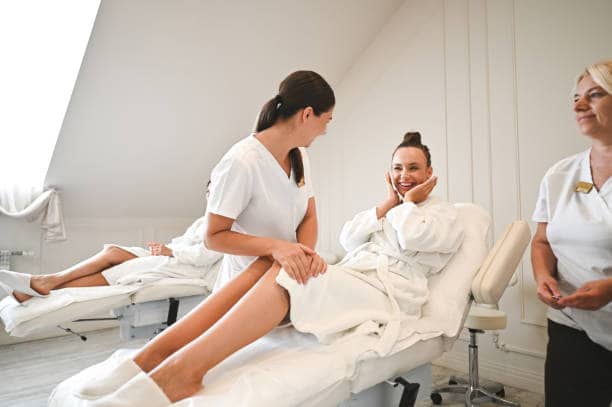 Client speaking with two professionals beside a treatment chair